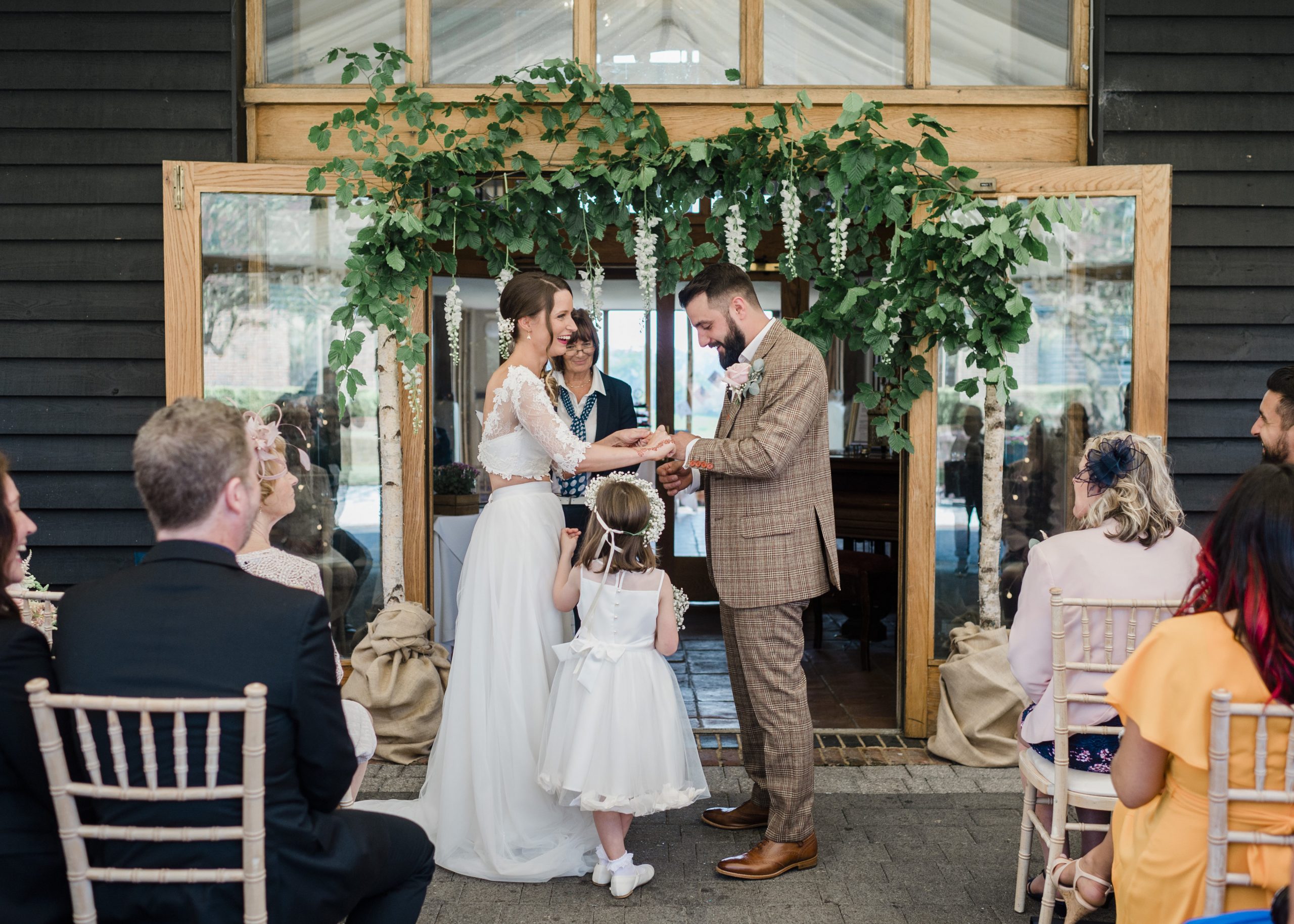 Gemma and Aaron exchanging rings at their wedding ceremony